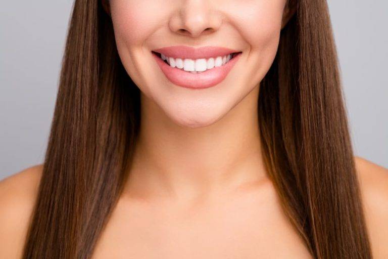 Woman With Brown Hair And Big, Straight White Smile