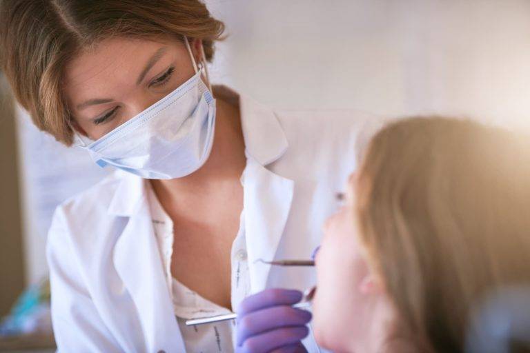 a dentist inspecting oral hygiene on a patient